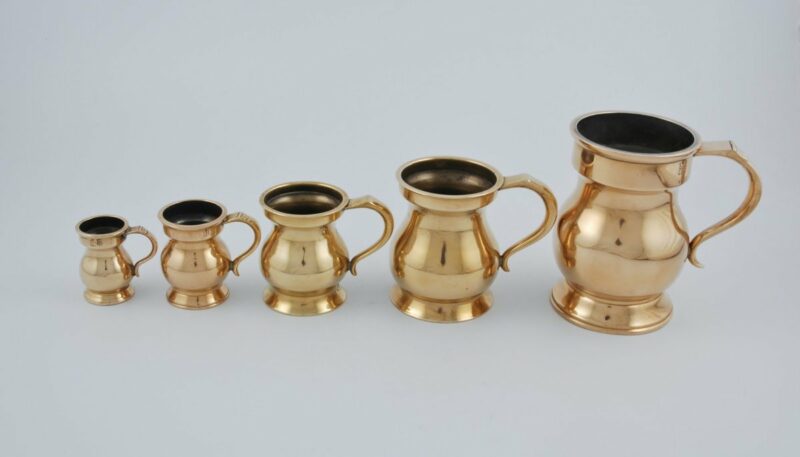 Set of 5 late 19th century English brass measures by Warne & Co.