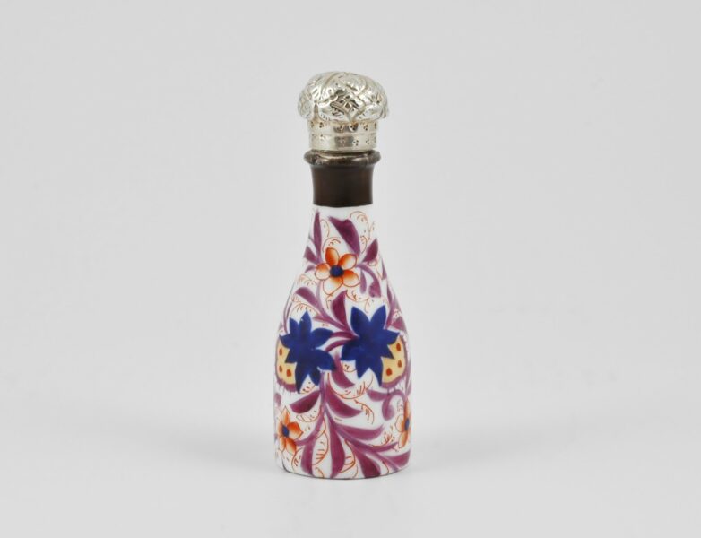 Victorian novelty glass, bottle shaped, scent bottle with silver lid modeled as a cork. Circa 1880.