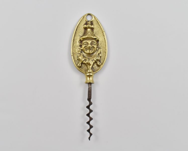 An English cast brass single sided corkscrew with a depiction of Mr Punch.