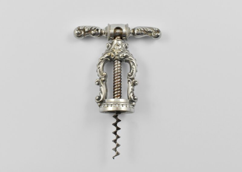 A German chrome plated brass decorative open frame corkscrew with swivel-over collar on the revolving handle. This unmarked example shown in the Thuringian catalogues as Reissmann’s patent. Perfect centre cut worm. Circa 1915.