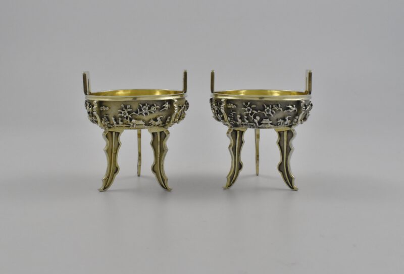 A pair of late 17th century Chinese, parcel-gilt, silver Ding incense burners with scratched Inventory numbers “No 99” to the bases.