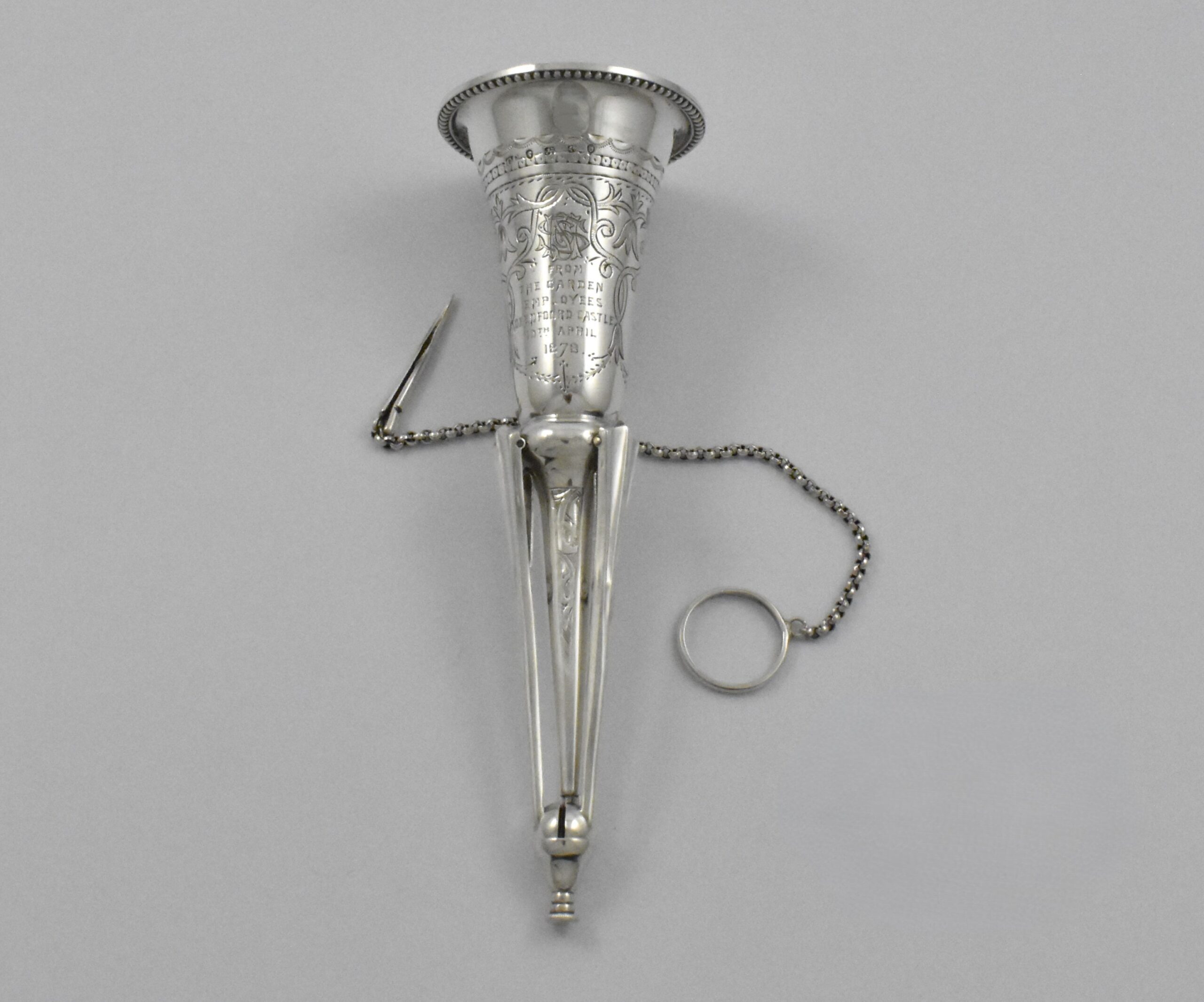 Victorian silver posy holder with finger ring and flower pin marked for London 1878. Incorporated into the handle are three sprung legs allowing it to stand. Engraved: “FROM THE GARDEN EMPLOYEES OXENFOORD CASTLE 10TH APRIL1878” by Colen Hewer Cheshire. - Image 2