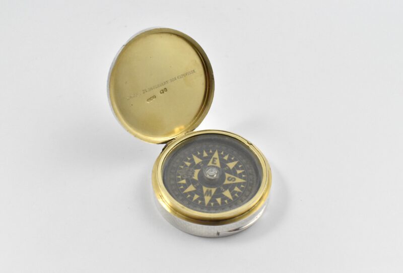Victorian silver compass in an engine turned case marked for London 1871 by Henry William Dee with Retailers mark: “Jones 23 Boulevart des Capucines”. Marked to the interior with a part-mark and with French control marks. The main silver mark is probably struck in the case below the compass.