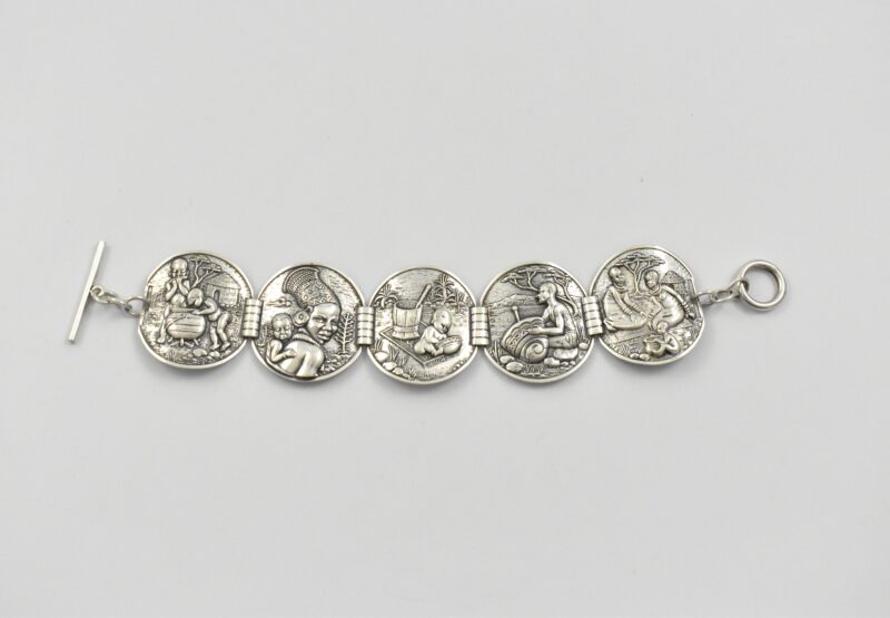South African sterling silver Candida “Velia” range bracelet designed by Joe Calafato, featuring African domestic scenes and marked “STER.SIL”, circa 1970.