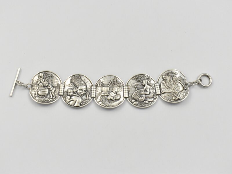 South African sterling silver Candida “Velia” range bracelet designed by Joe Calafato, featuring African domestic scenes and marked “STER.SIL”, circa 1970.