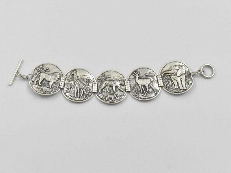 South African sterling silver Candida “Velia” range bracelet designed by Joe Calafato, featuring African animals and marked “SOUTH AFRICA STER.SILV RD 10260”, circa 1970.