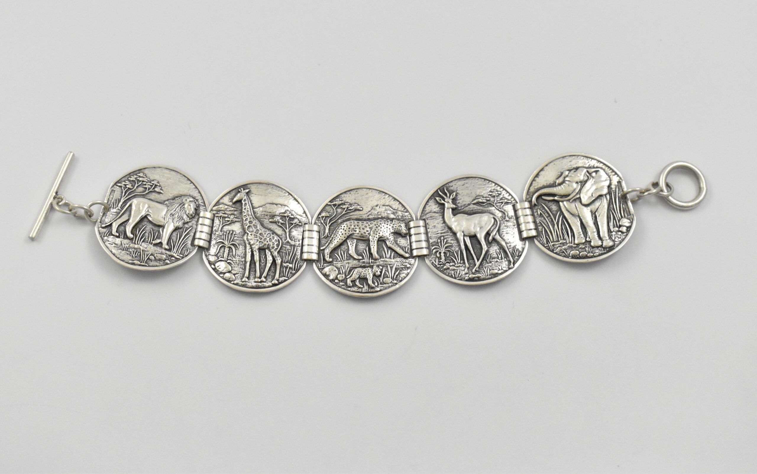 South African sterling silver Candida “Velia” range bracelet designed by Joe Calafato, featuring African animals and marked “SOUTH AFRICA STER.SILV RD 10260”, circa 1970. - Image 2