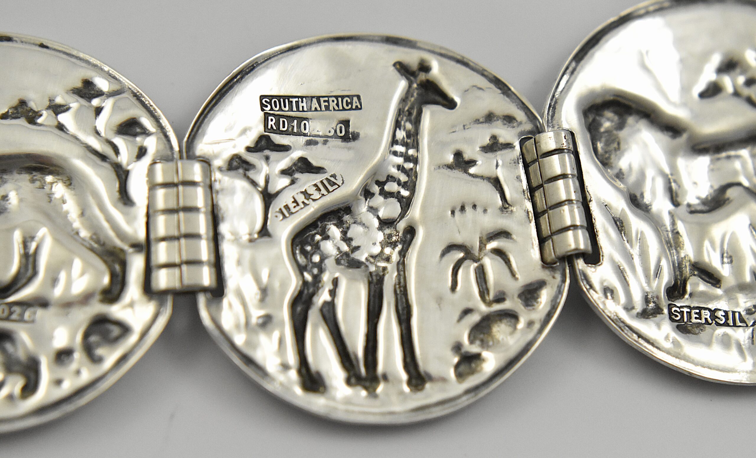 South African sterling silver Candida “Velia” range bracelet designed by Joe Calafato, featuring African animals and marked “SOUTH AFRICA STER.SILV RD 10260”, circa 1970. - Image 4