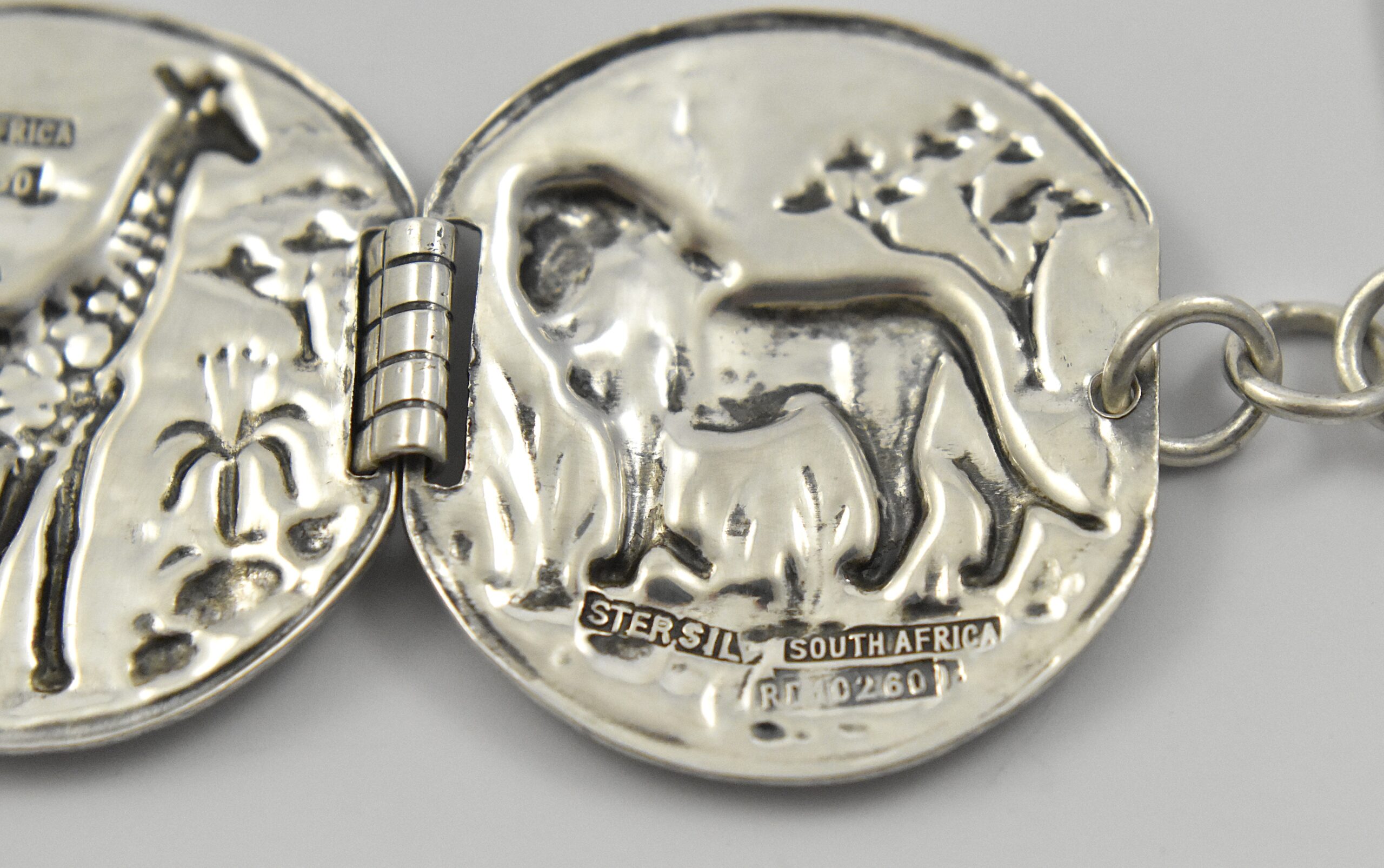 South African sterling silver Candida “Velia” range bracelet designed by Joe Calafato, featuring African animals and marked “SOUTH AFRICA STER.SILV RD 10260”, circa 1970. - Image 5