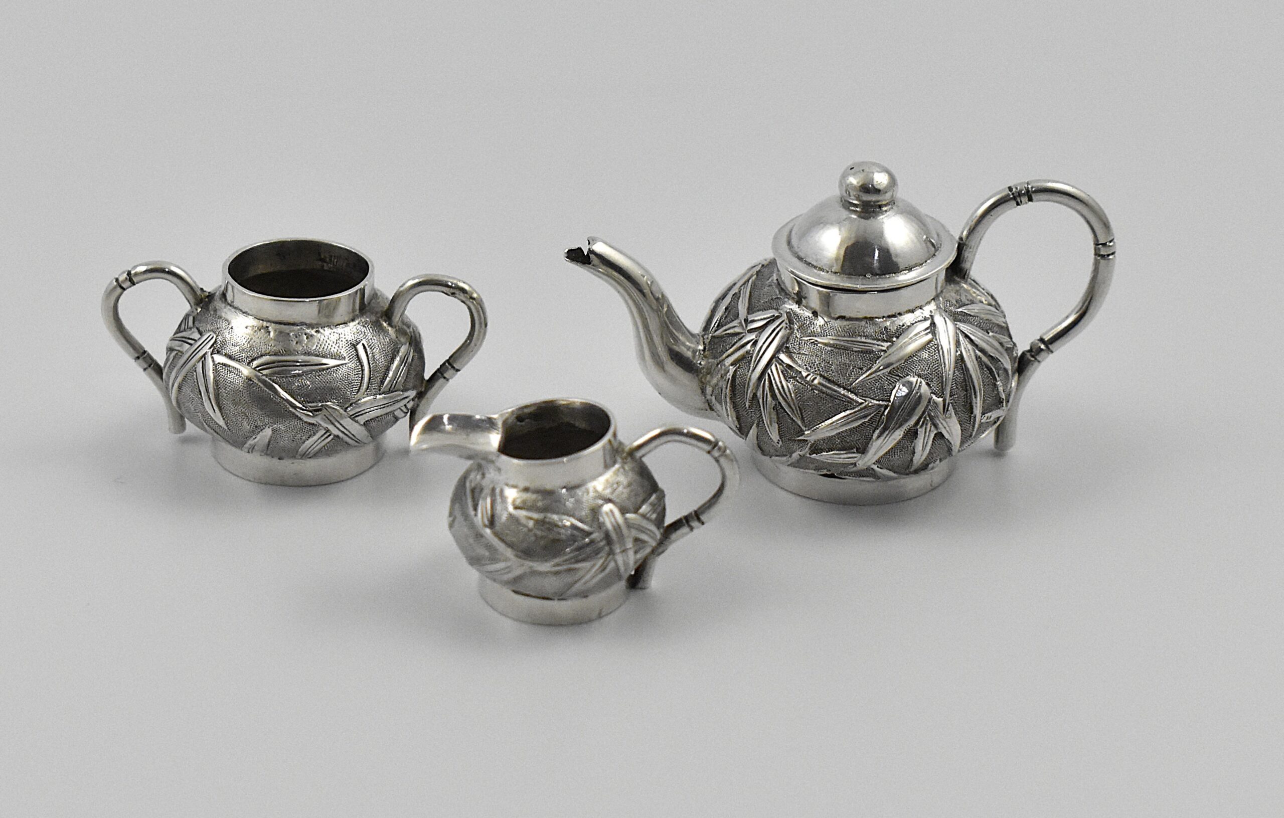 A late 19th century Chinese export silver miniature three piece tea set by Wang Hing, Canton & Shanghai, circa 1854-1925. - Image 2