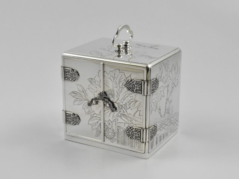 A Japanese silver and lacquer Meiji period (1868 -1912) jewellery box in the form of a chest of drawers, signed to the base.