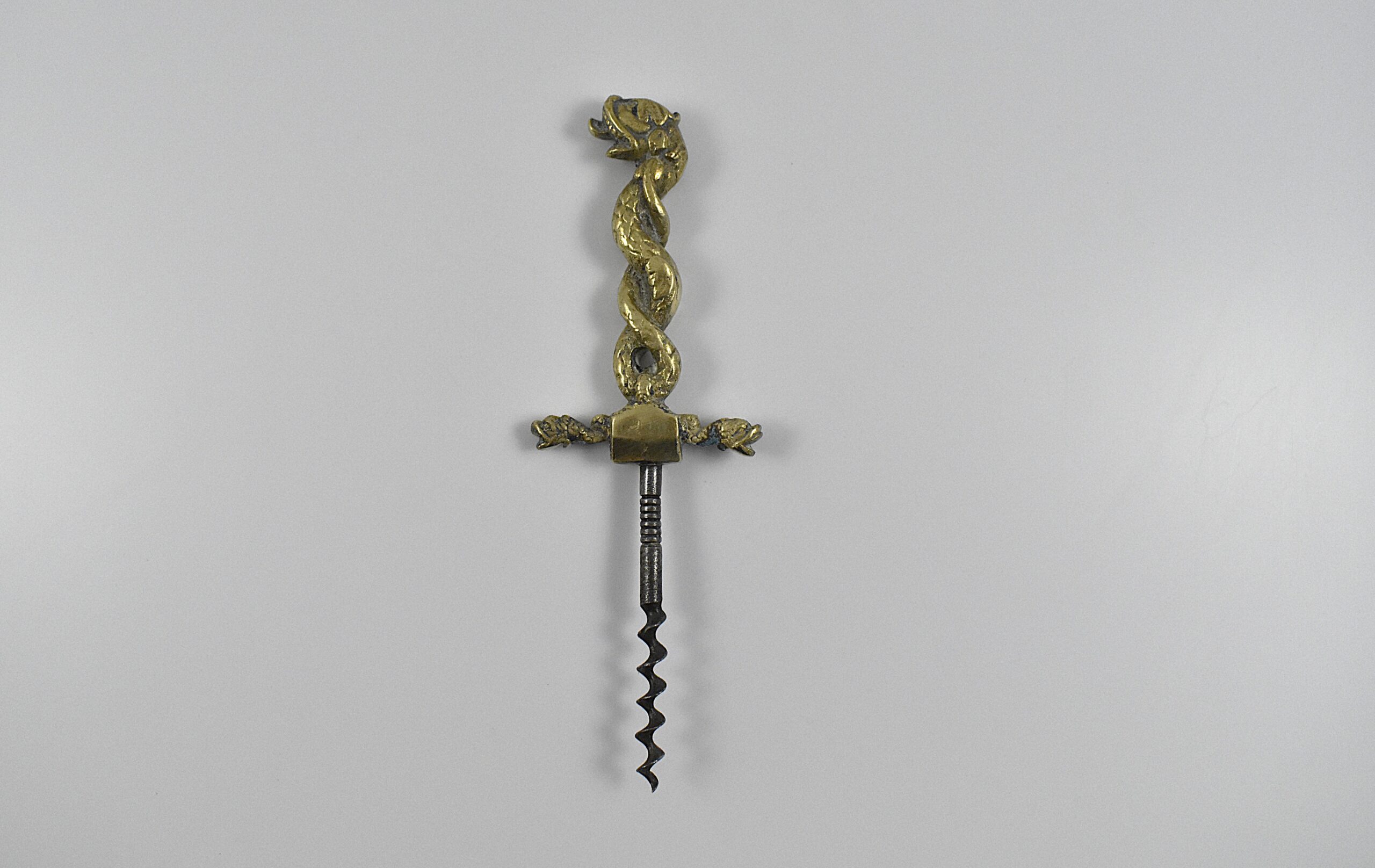 A magnificent mid-19th century English cast brass and steel corkscrew with a serpent design handle.