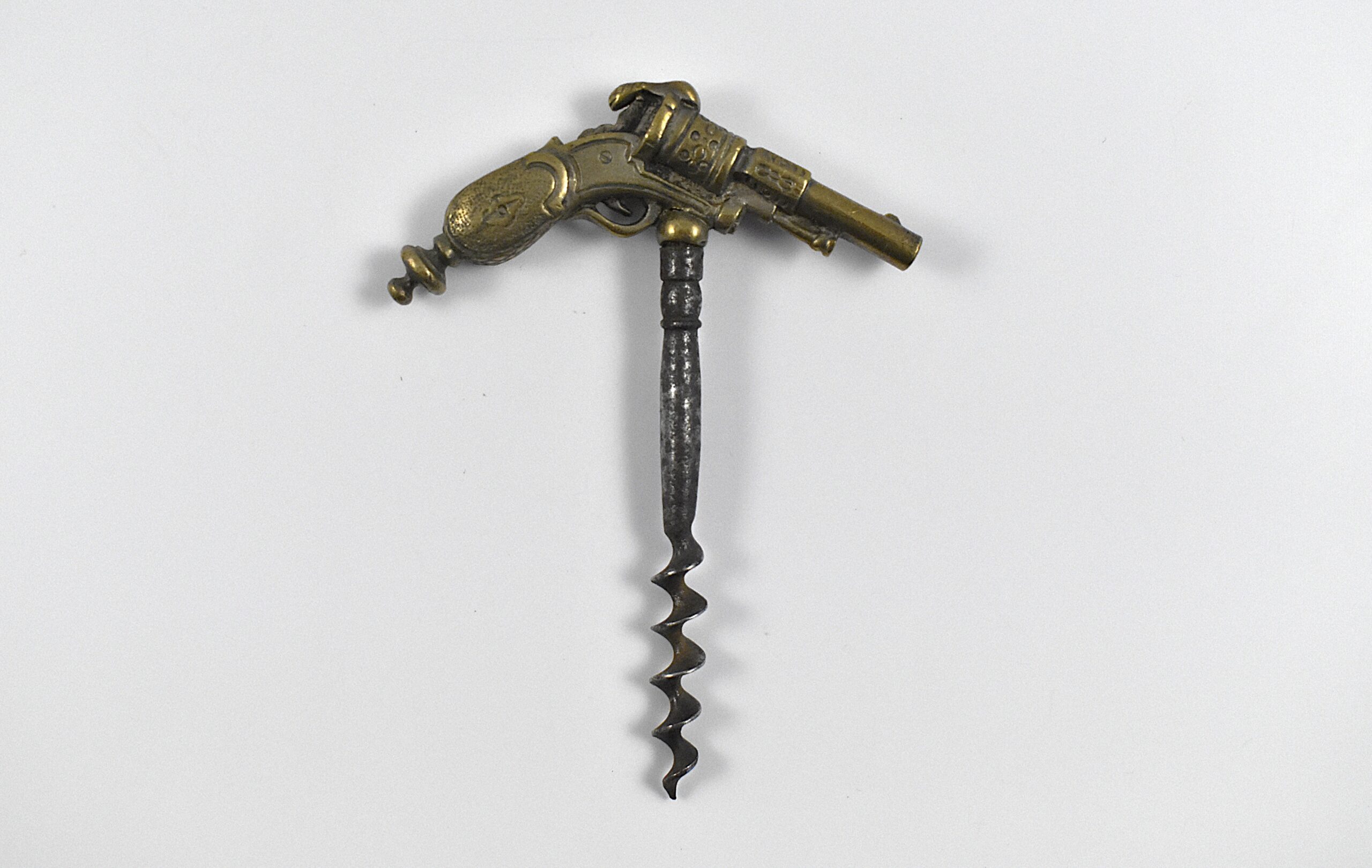 A French straight pull cast brass corkscrew with the handle in the form of a revolver.