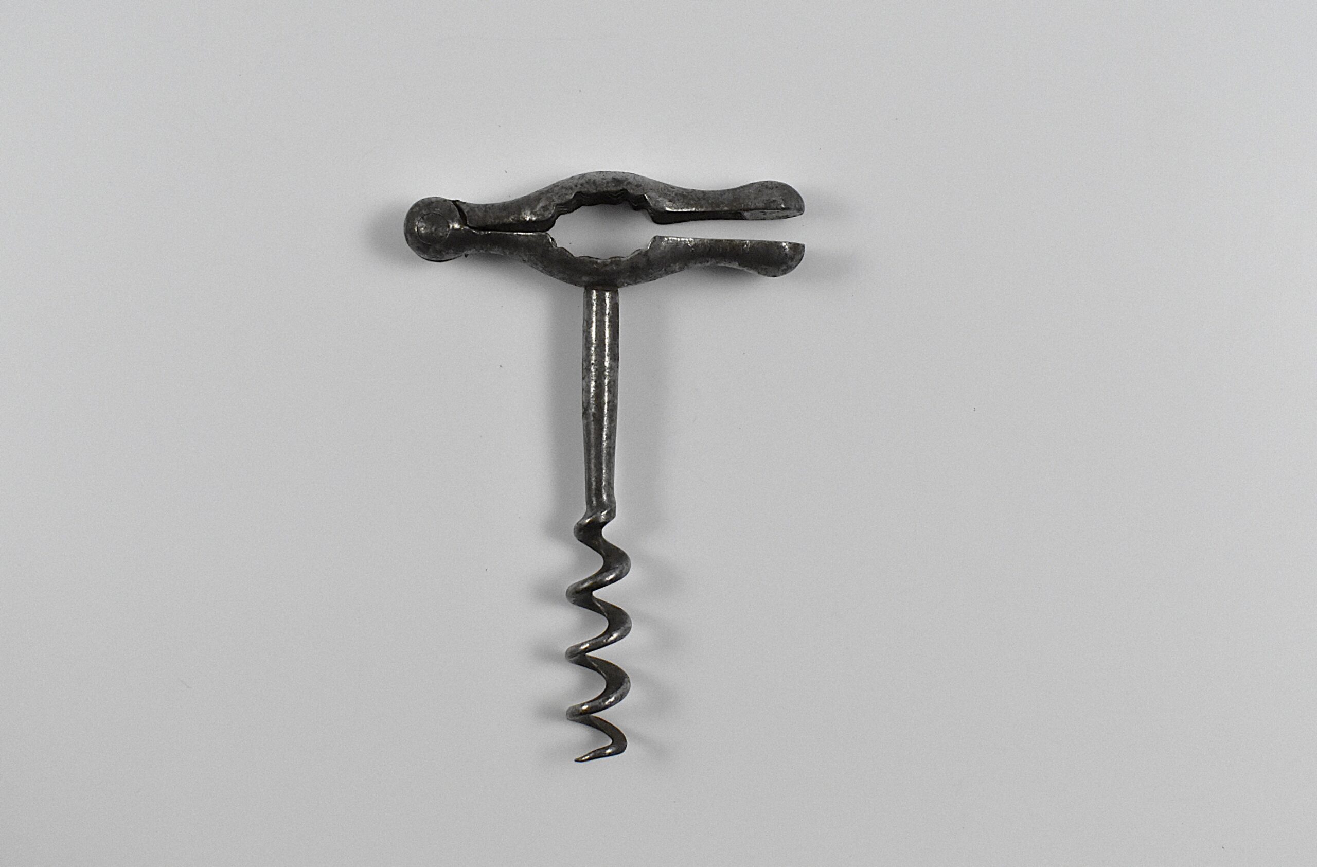 A rare French straight pull corkscrew with a folding handle containing a cork press. This example is marked “PORT ?? B SGDG” on the top.