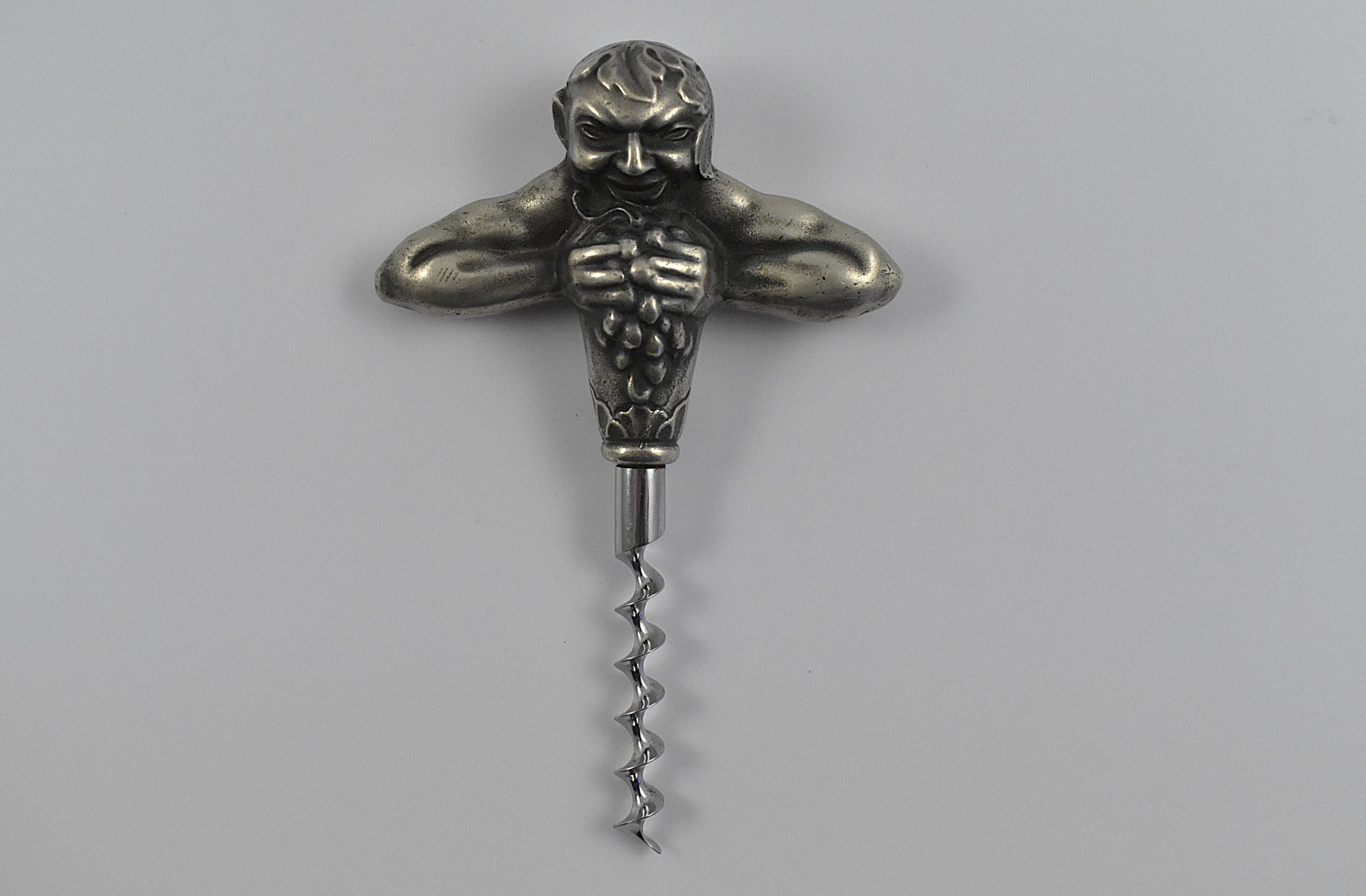 A Swedish straight pull corkscrew with a representation of Bacchus squeezing a bunch of grapes by the firm of Carl Victor Heljestrand (1816-1861).
