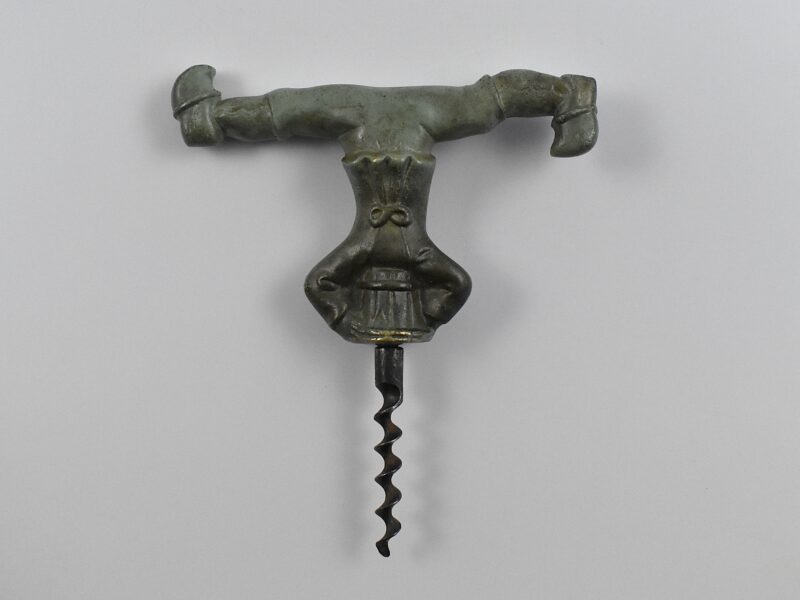 A Swedish cast bronze straight pull corkscrew with a representation of a Dutch man wearing clogs with his head stuck in a barrel.