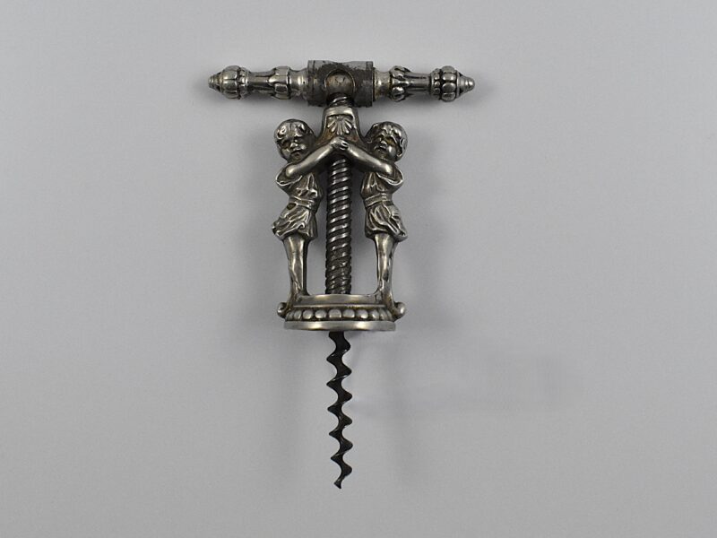 A German chrome plated cast decorative corkscrew with two girls forming the frame, having a swivel-over collar on the revolving handle. This is shown in the Thuringian catalogues as Reissmann’s patent.