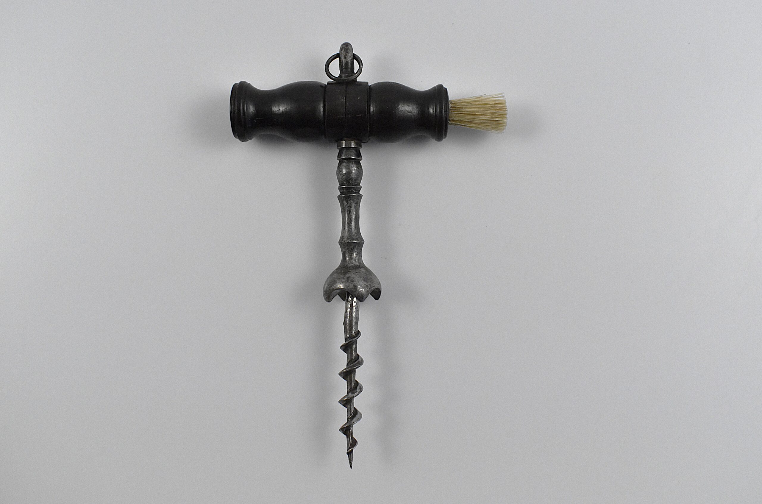 A French straight pull corkscrew with turned wooden handle incorporating a dusting brush and hanging ring.