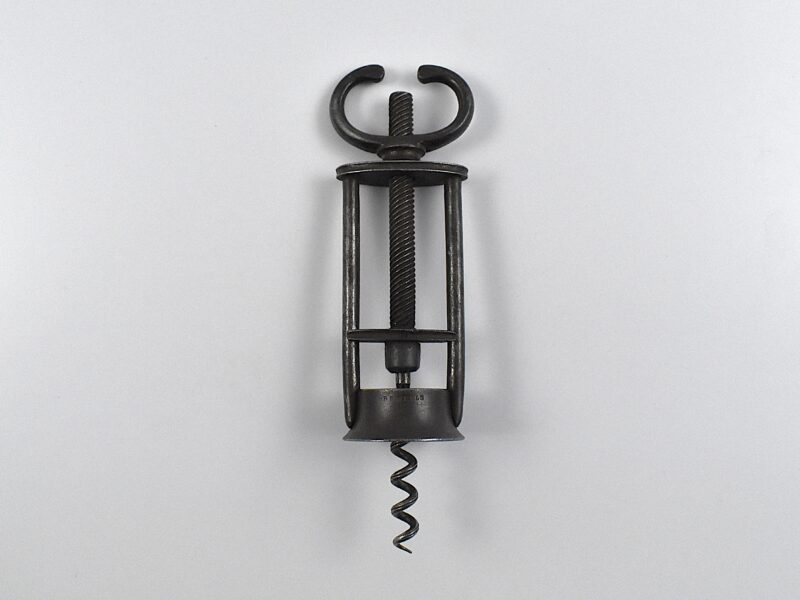 An English open frame two pillar corkscrew with a fixed wing nut handle retailed by B B WELLS of 431 WEST ST STRAND.