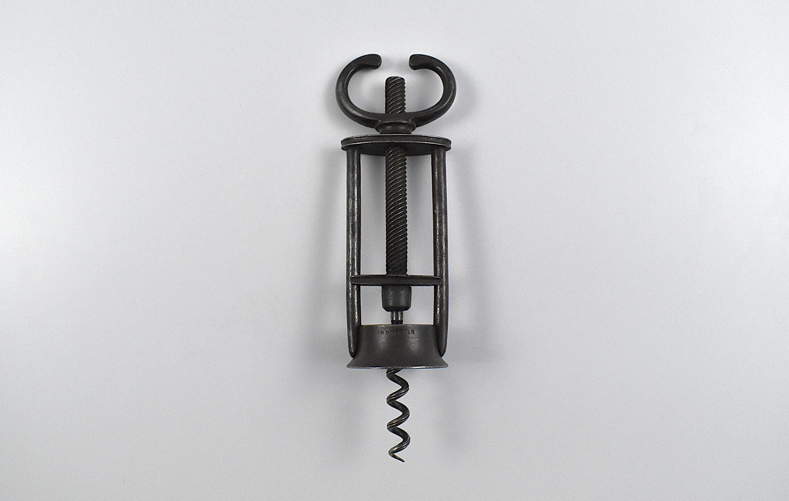 An English open frame two pillar corkscrew with a fixed wing nut handle retailed by B B WELLS of 431 WEST ST STRAND.