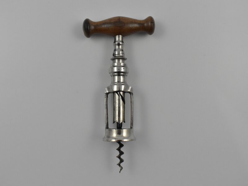 A German chrome plated steel open frame corkscrew with turned wood handle known as the “Mauser”. The handle is turned into the cork and when it engages the top of the second shaft this reverses and extracts the cork from the bottle. This was a German Empire registered design granted to Louis Kummer on the 14th of July 1904 and shown in his 1909 catalogue as the “Mauser”.