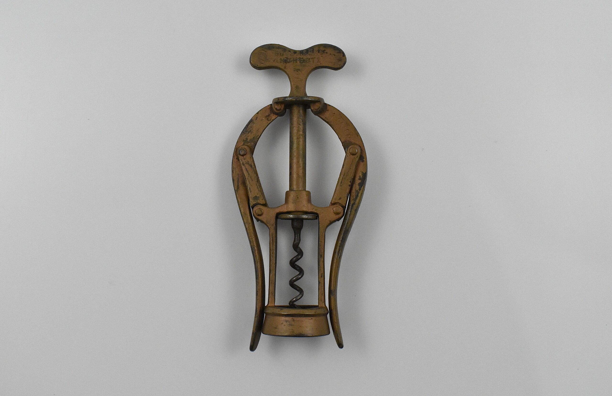 An all-steel James Heeley & Sons double lever corkscrew with the original copper bronze wash. This example marked “JAMES HEELEY & SONS 6006 PATENT DOUBLE LEVER” on the handle and ‘A 1 PATENT’ on the arms. Neville Smith Heeley trading as James Heeley and Sons of Graham Street, Birmingham was granted a patent No. 6,006 on the 23rd of April 1888 for this design.
