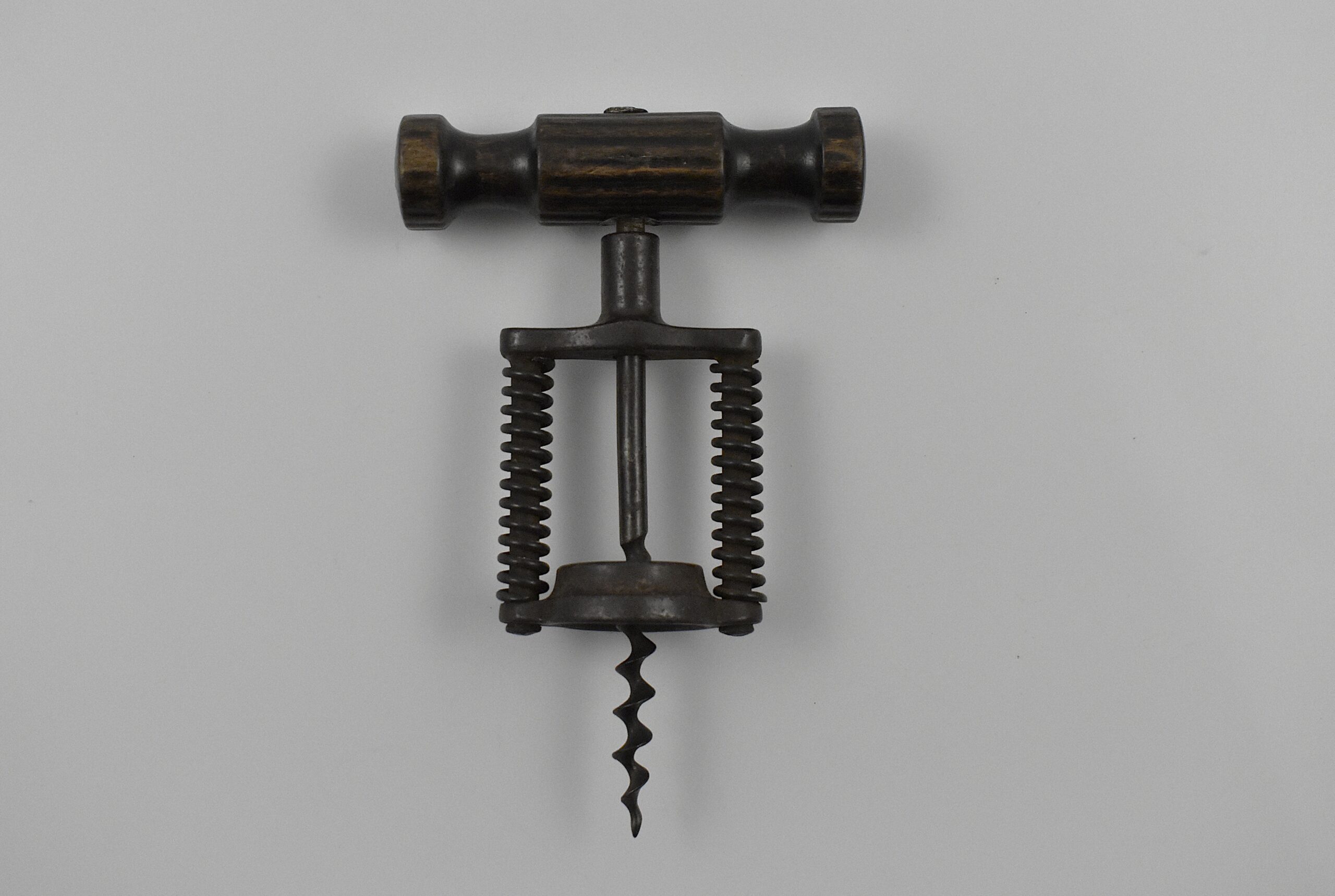 A German open frame corkscrew with continuous action having a double spring assisted frame. The frame is marked D.R.G.S” (Deutsches Reichs Gebrauchsmuster Schutz) which means it was protected by a registered design in the German Empire.