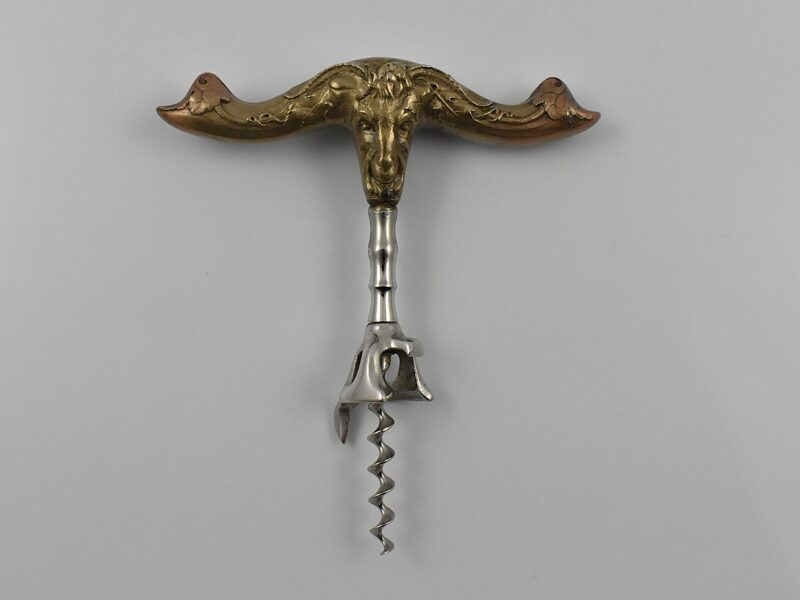 An American hollow brass handled bell cap corkscrew by Reed & Barton with internal rolling ball, the bell cap designed by Walker. The handle moulded with a figure of Baccus and grape vines and is marked “REED & BARTON’ on one side and “42 BN” on the other.